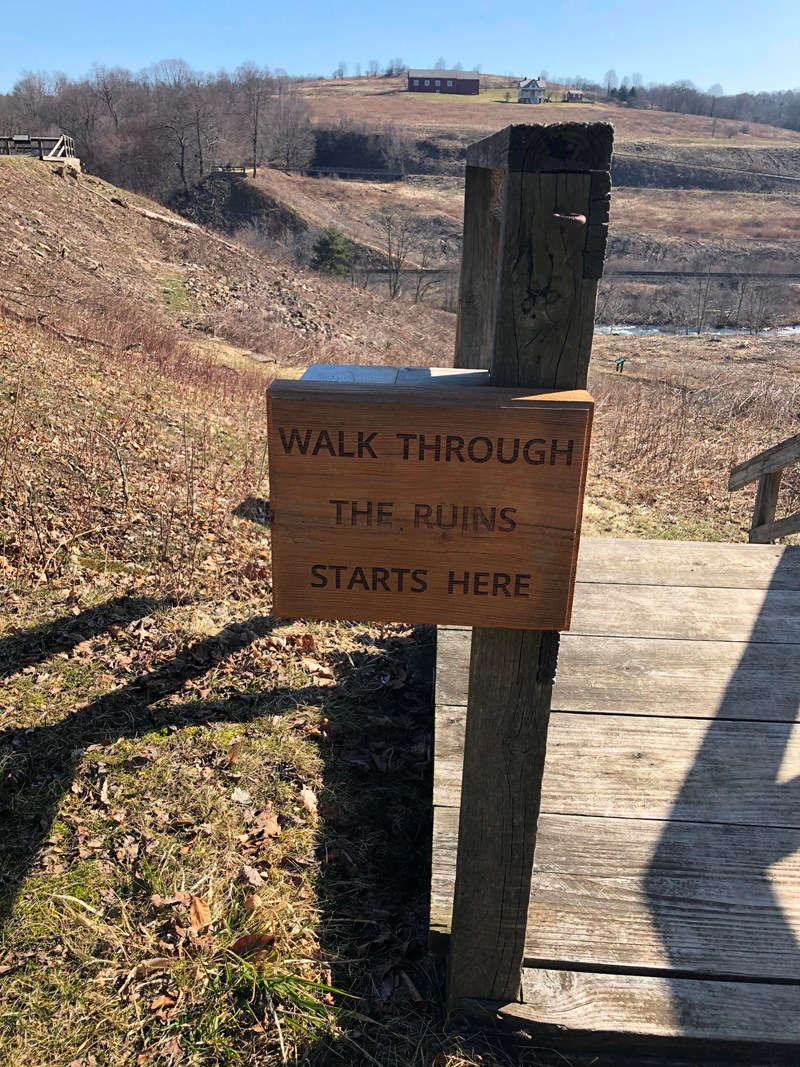 A Walk Through the Ruins starts near the South Abutment. Wooden sign