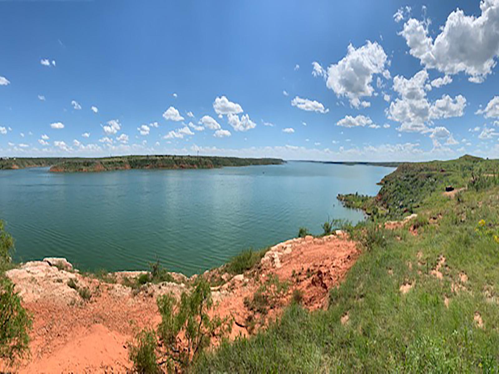View from a mesa of Lake Meredith.  The sky is blue with a few white clouds.