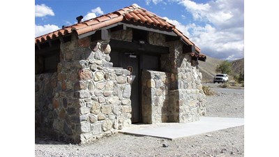a stone building with red roof tiles