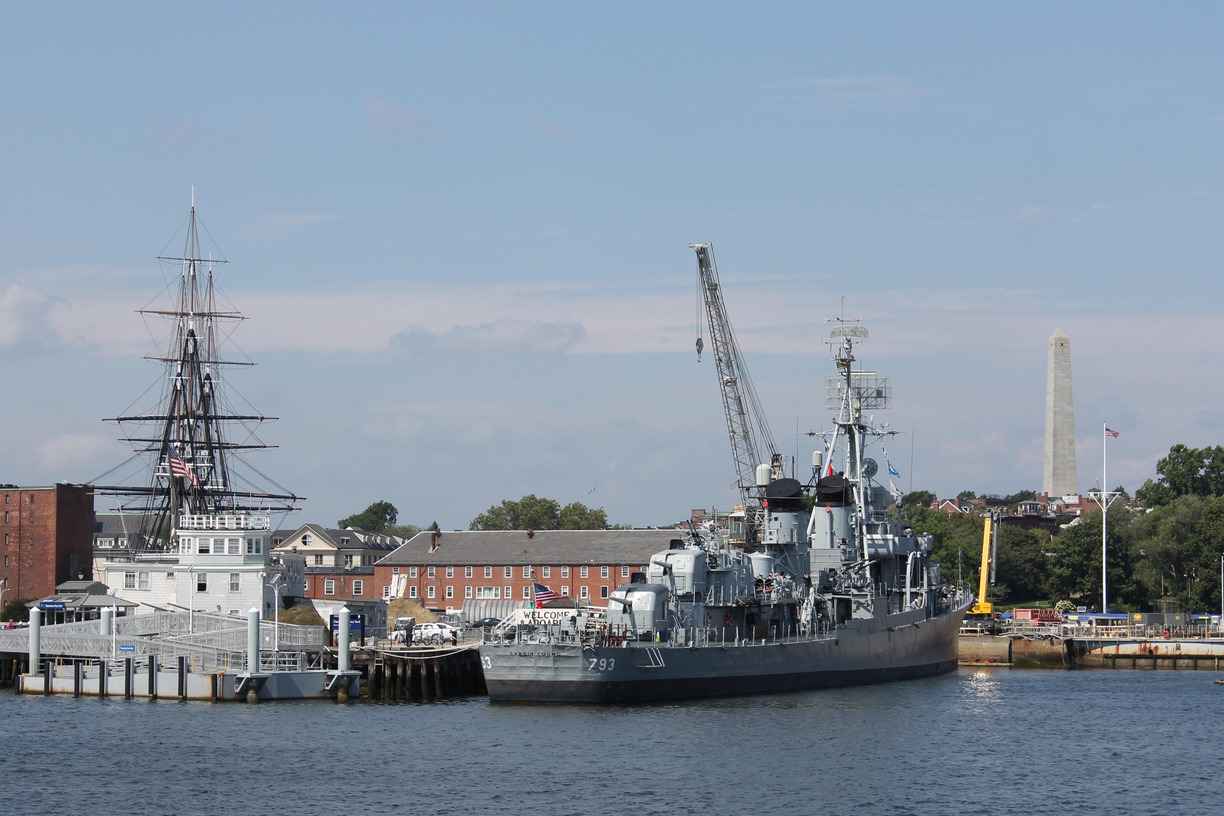 View of the Navy Yard from the harbor showing the USS Constution, USS Cassin Young and Bunker Hill