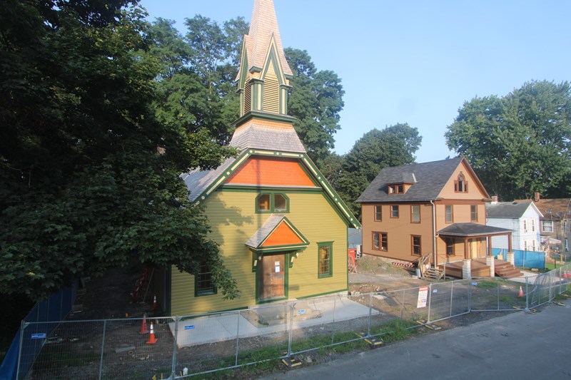 Thompson Memorial A.M.E. Zion Church Wooden church with tall steeple, with construction equipment out front.