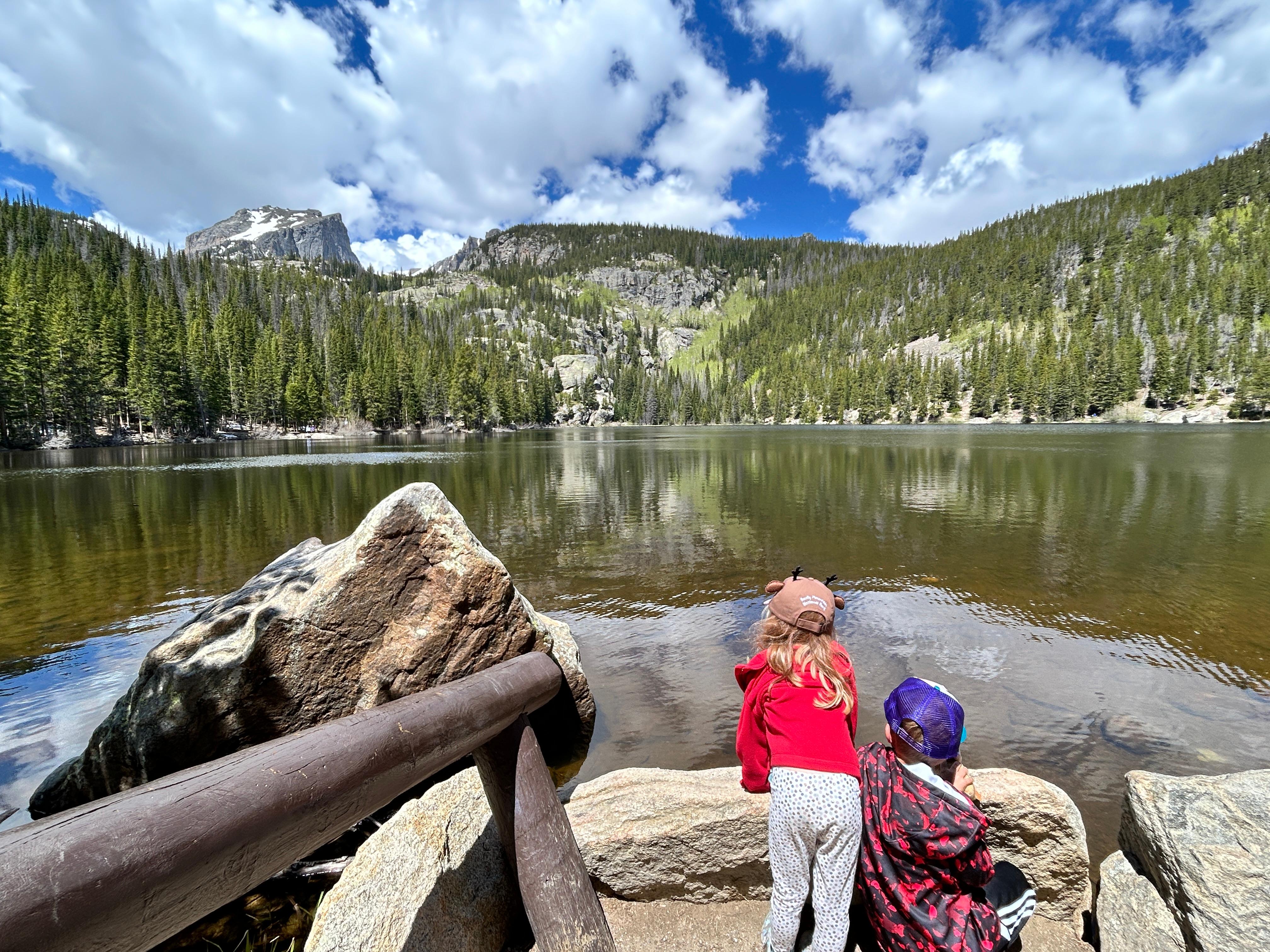 Two Junior Rangers are looking out at Bear Lake