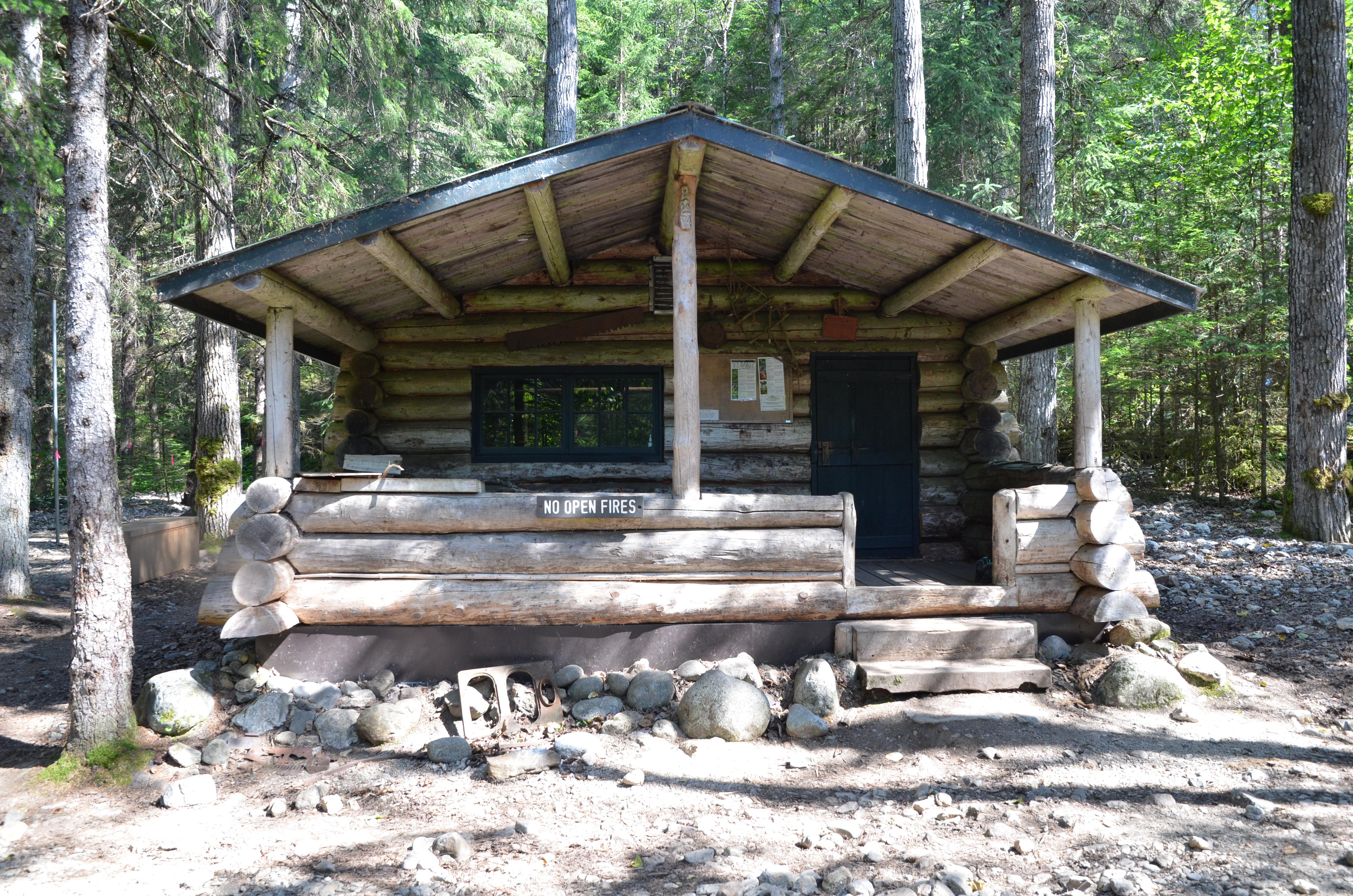 Front view of a log cabin with porch