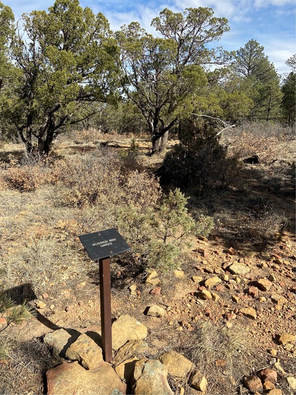 Metal sign along a trail