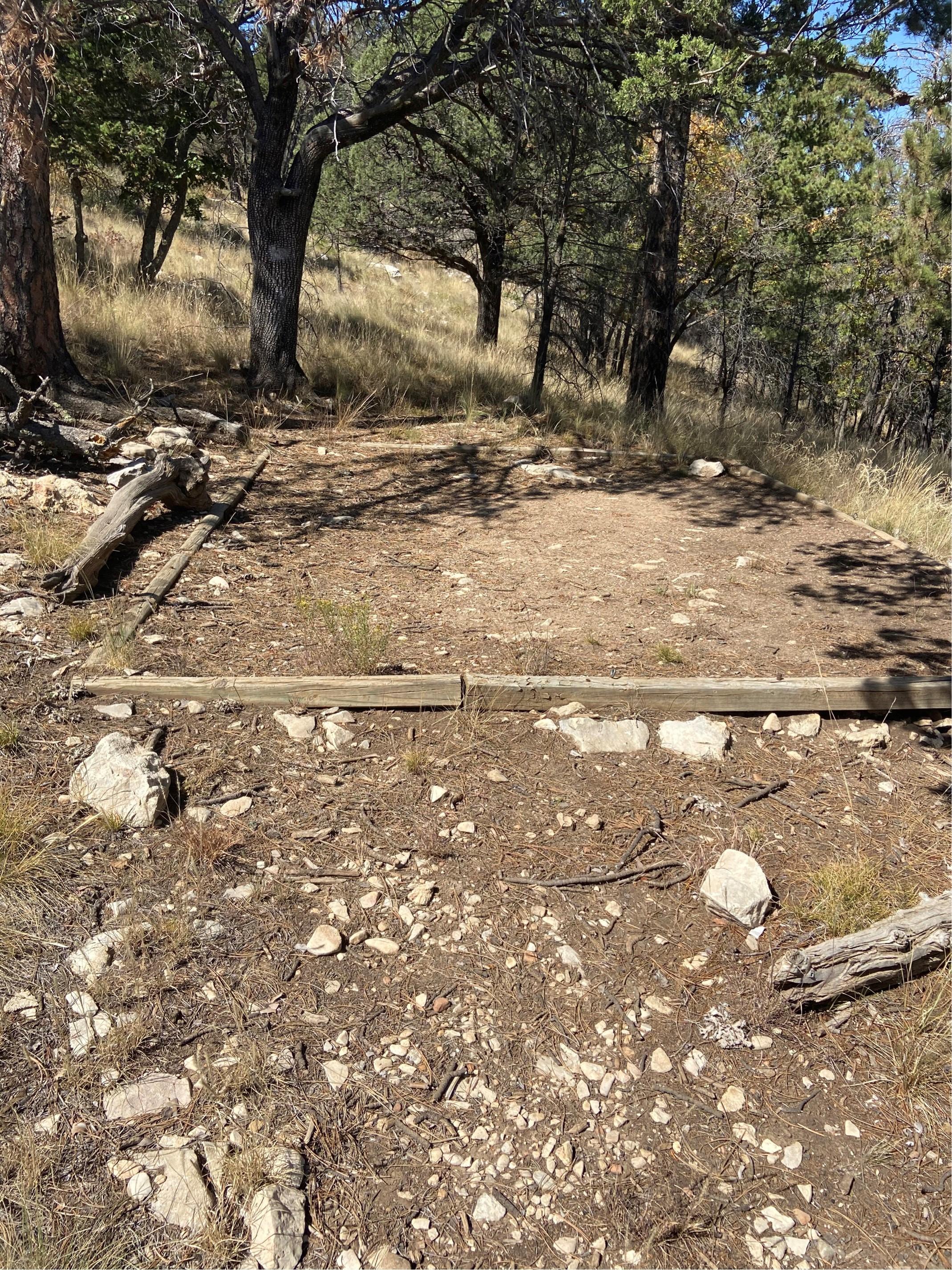 A hardened dirt surface in a rocky mountain landscape