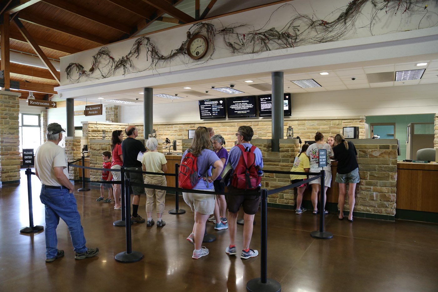 Visitors standing in line at a counter to buy cave tour tickets
