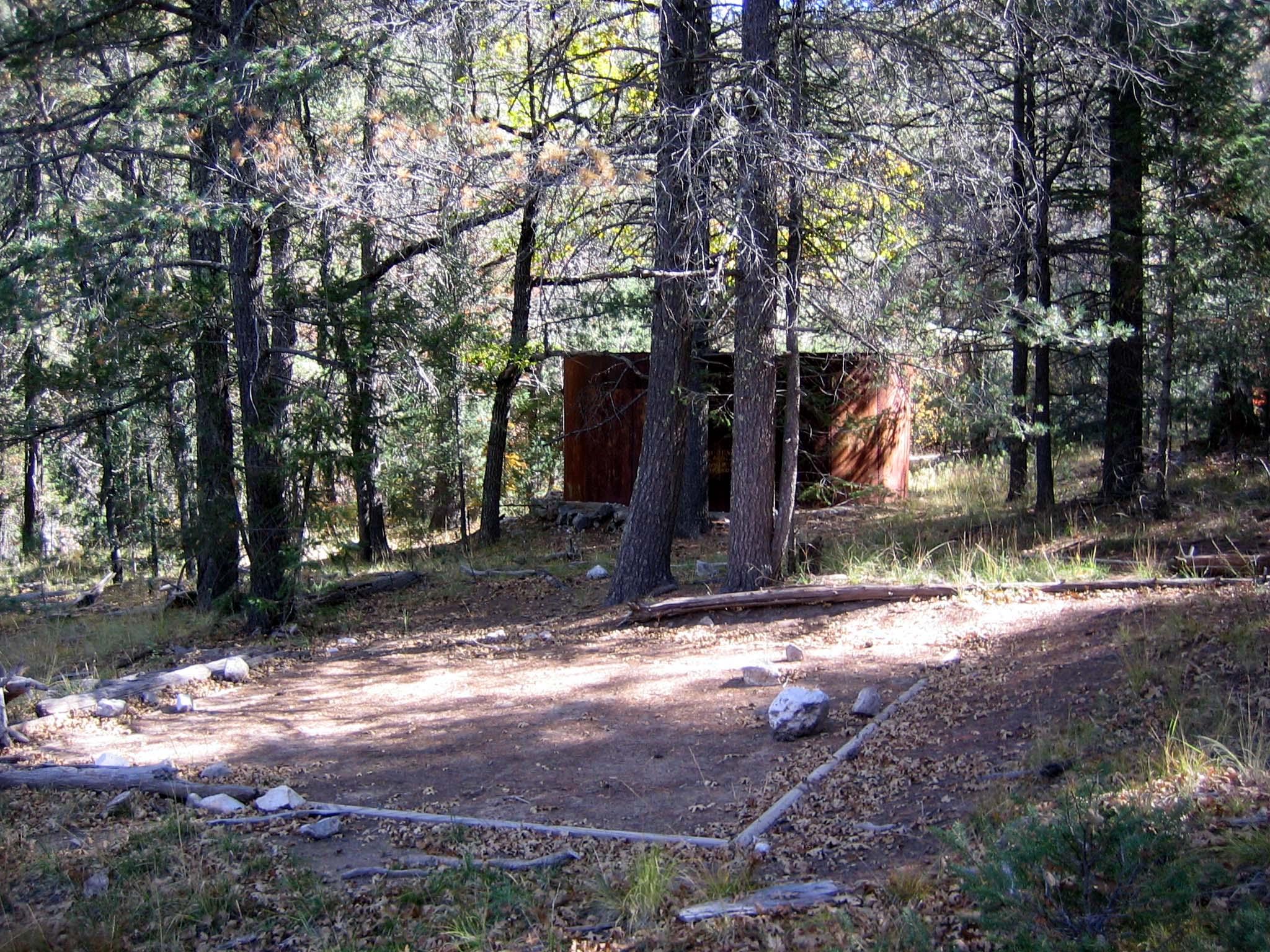 A hardened surface for a tent in near an old metal water tank