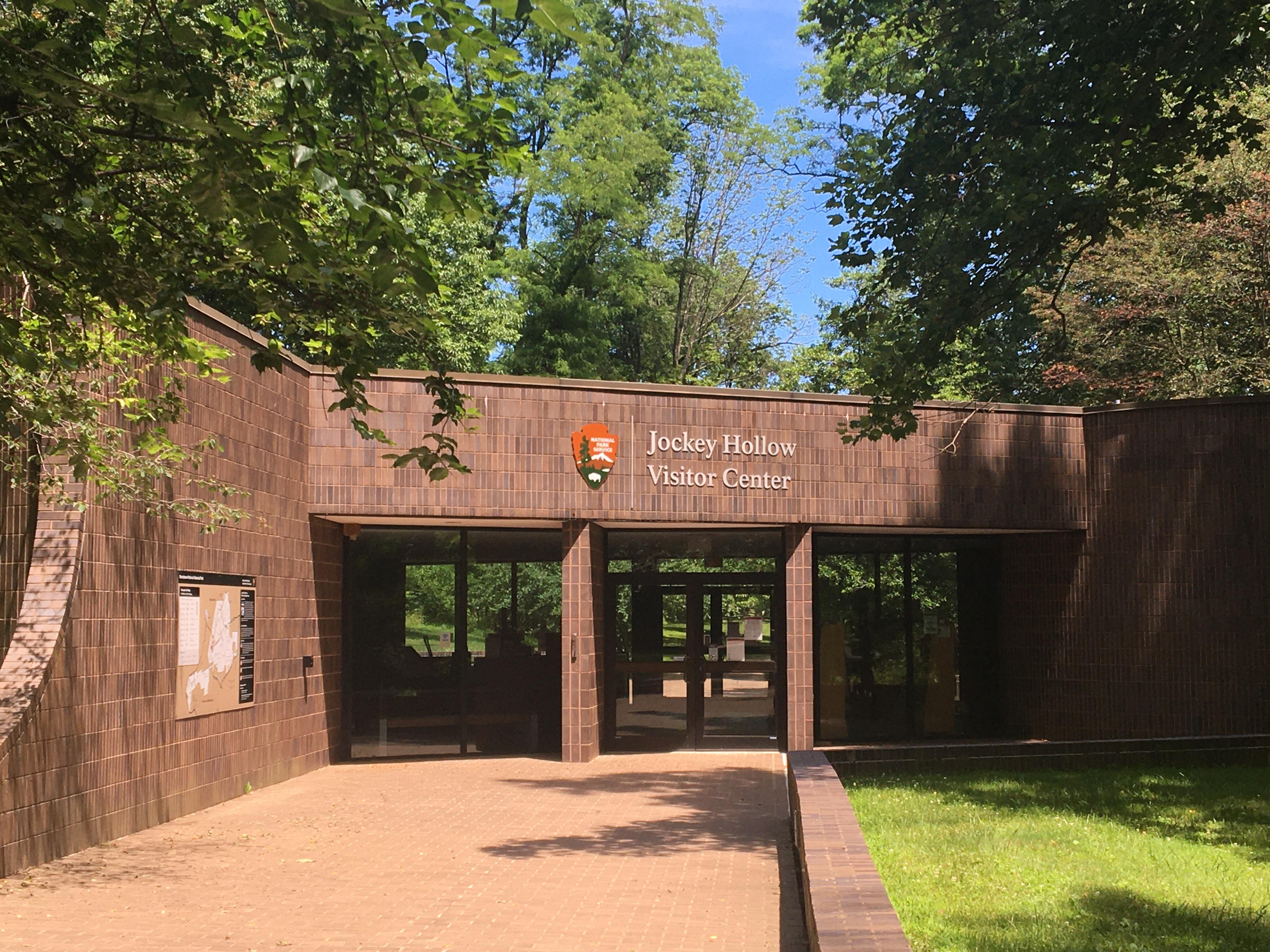 View of the front facede of the Jockey Hollow Visitor Center--a dark brown brick buildings