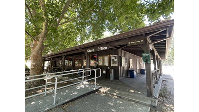 Ramp onto a wooden wrap around deck of a campground store