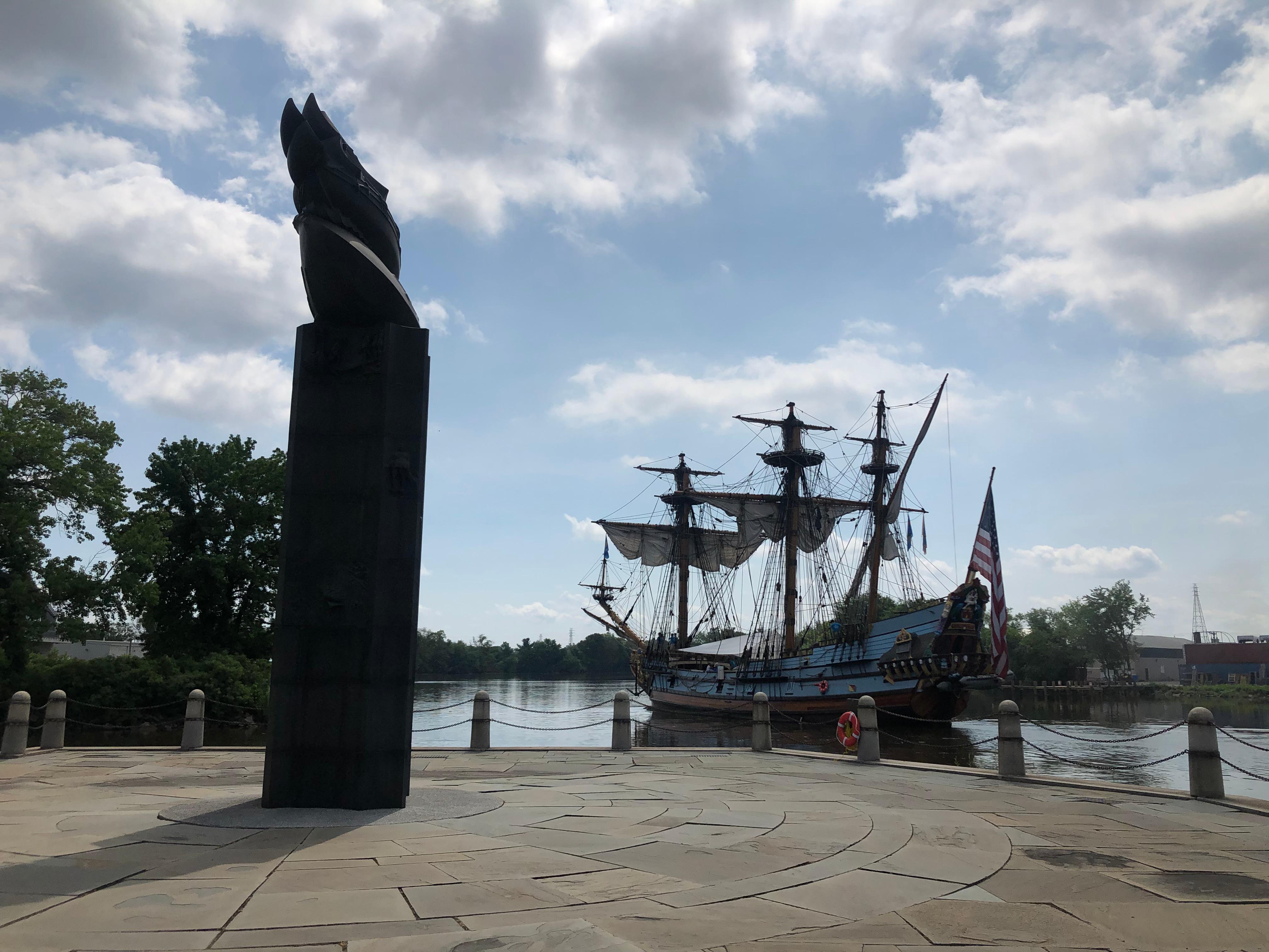 A replica of the original Kalmar Nyckel ship sails by the monument at Fort Christina.