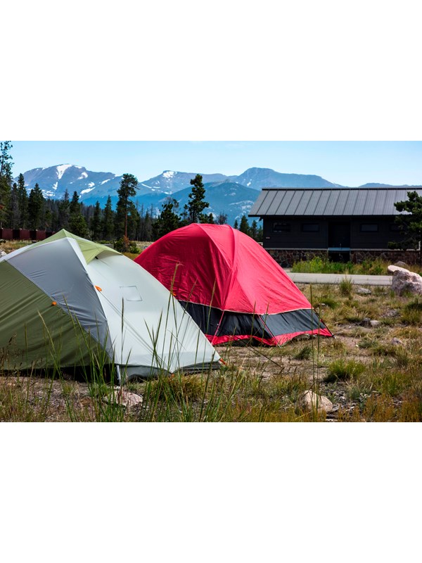 Tents in the foreground with snowy peaks behind