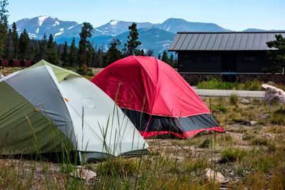 Tents in the foreground with snowy peaks behind