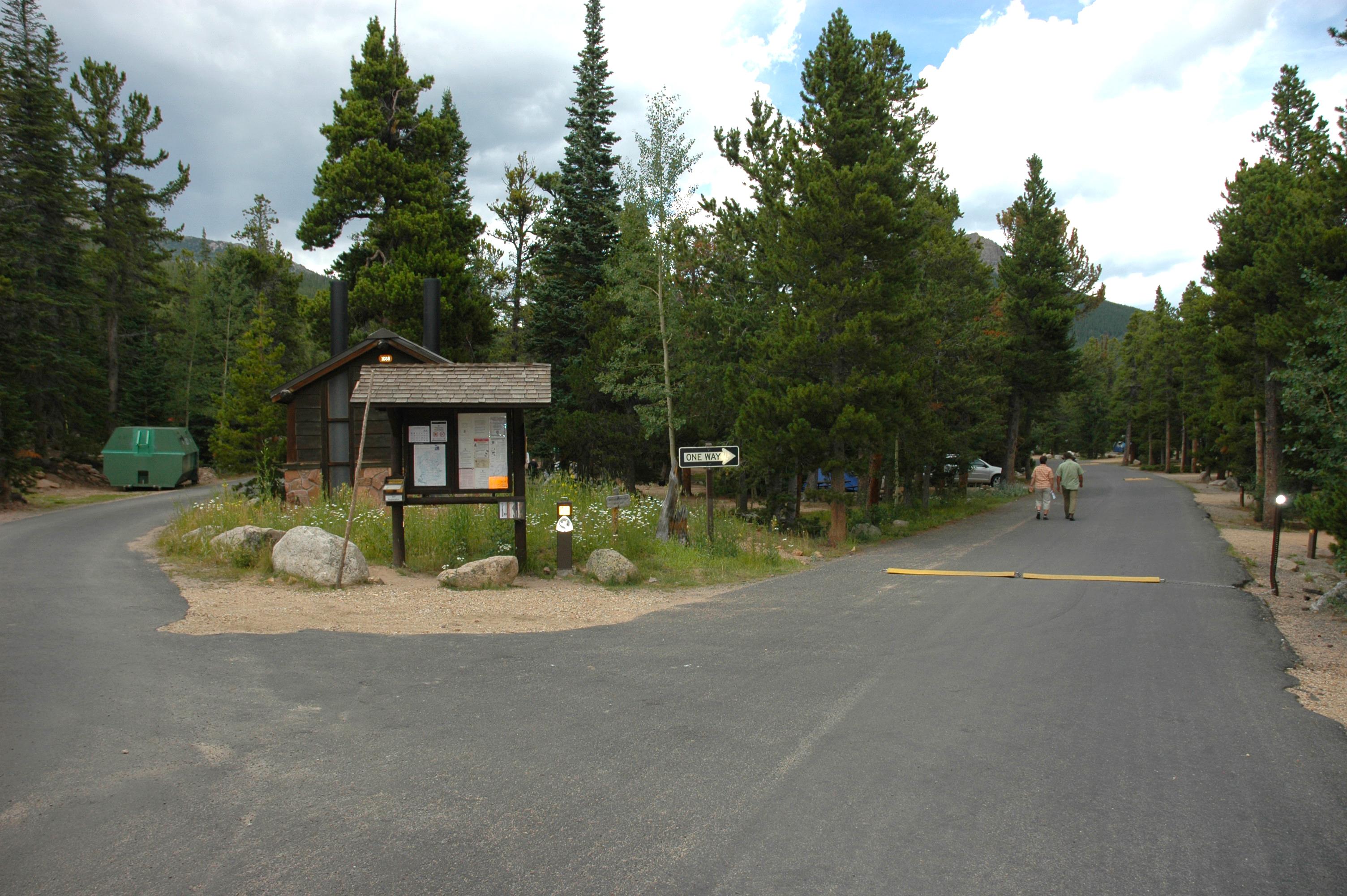 Paved road with sign in background