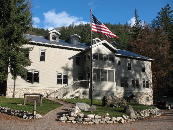 A white building with an American flag in front