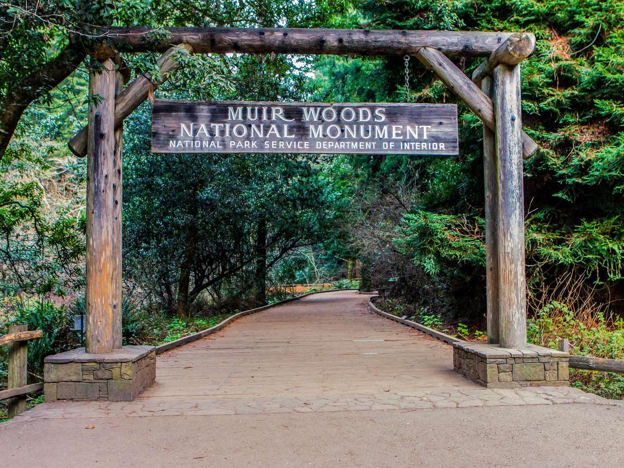 Wooden sign and entrance to Muir Woods National Monument