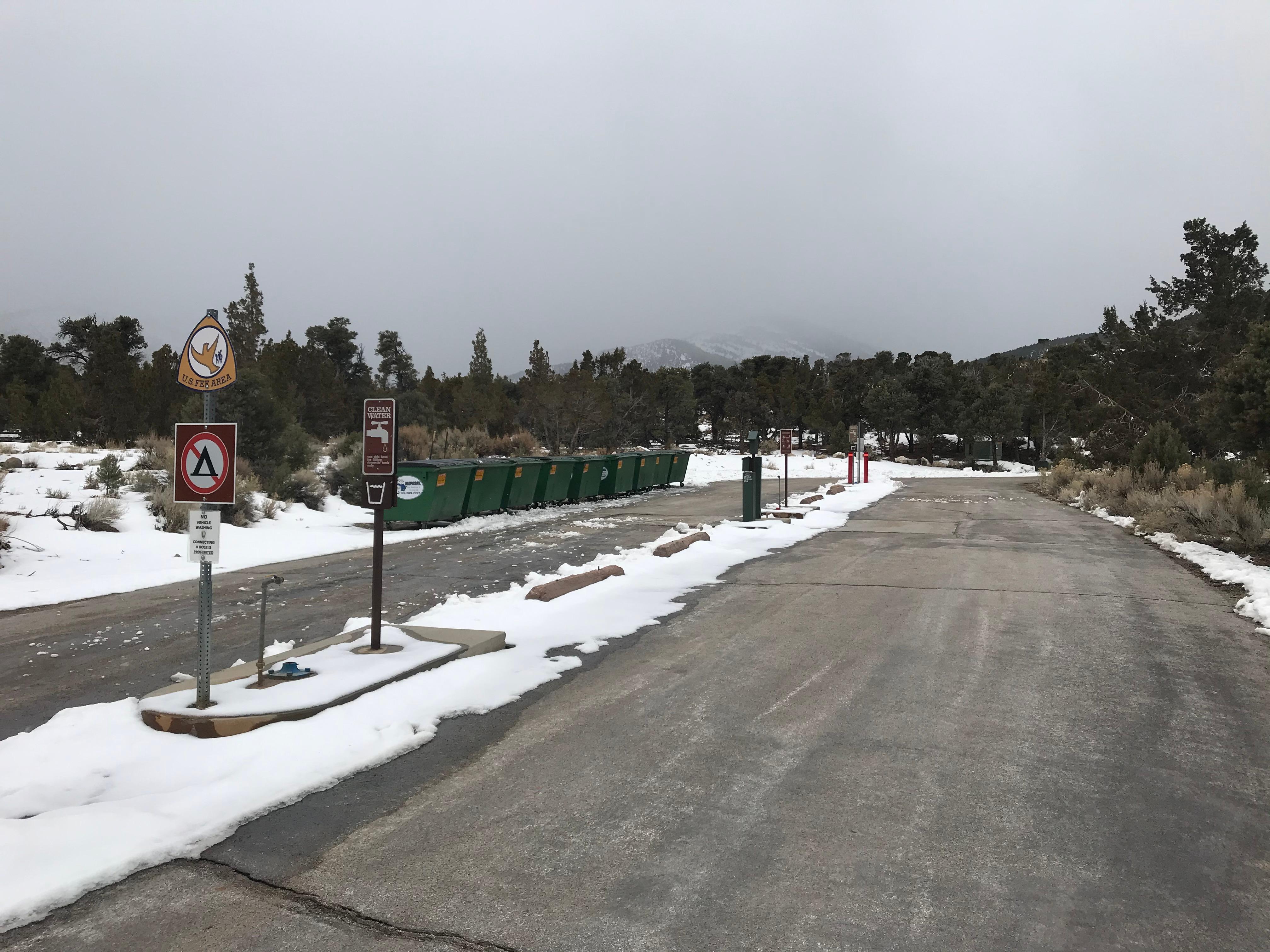 Great Basin Dump Station with sewage hose, water fill up, and dumpsters