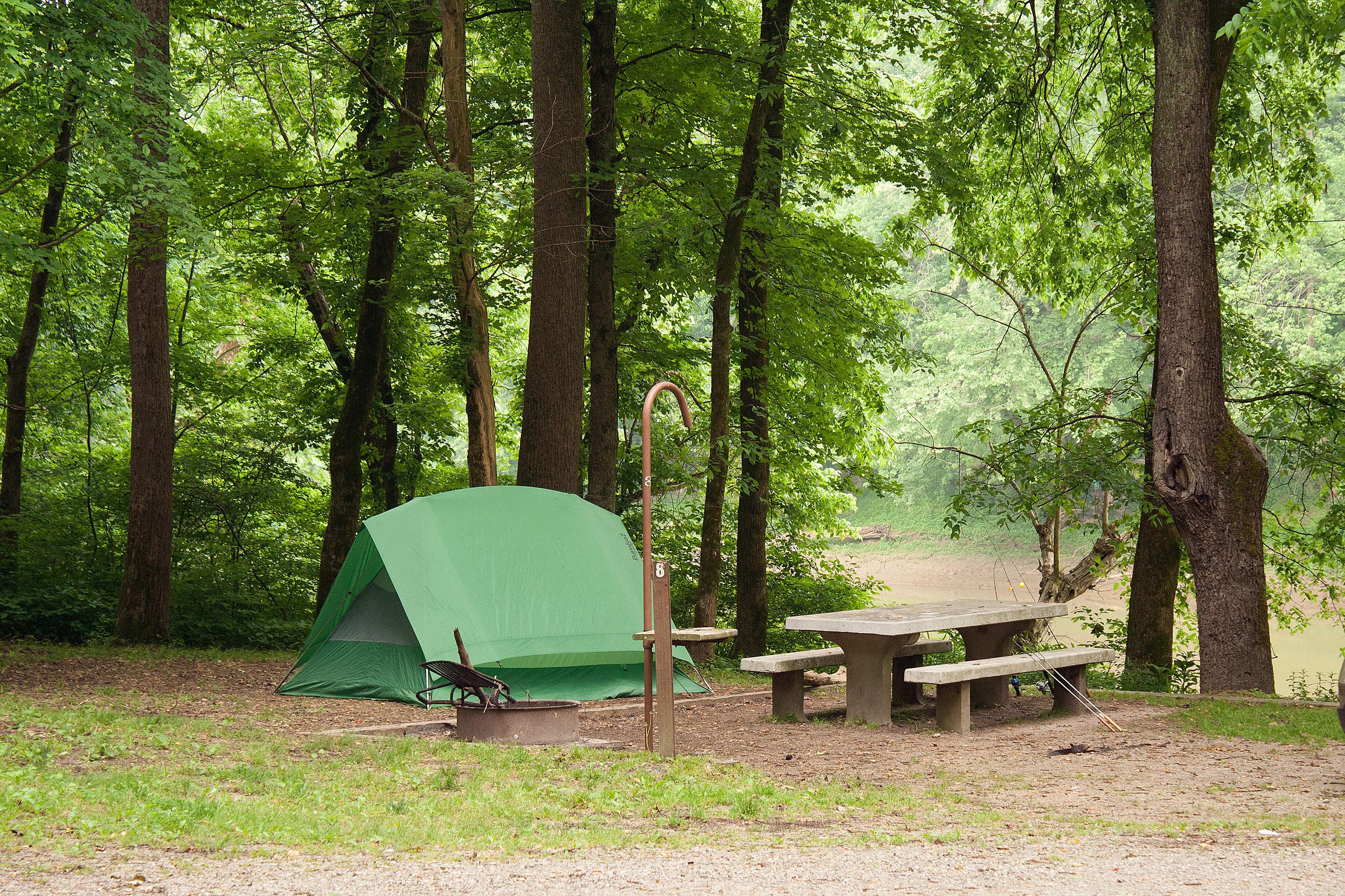 A Houchin Ferry campsite with tent, fire ring, picnic table and lantern hook overlooks Green River.