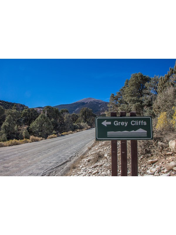 Green sign with white text that says "Grey Cliffs Campground"