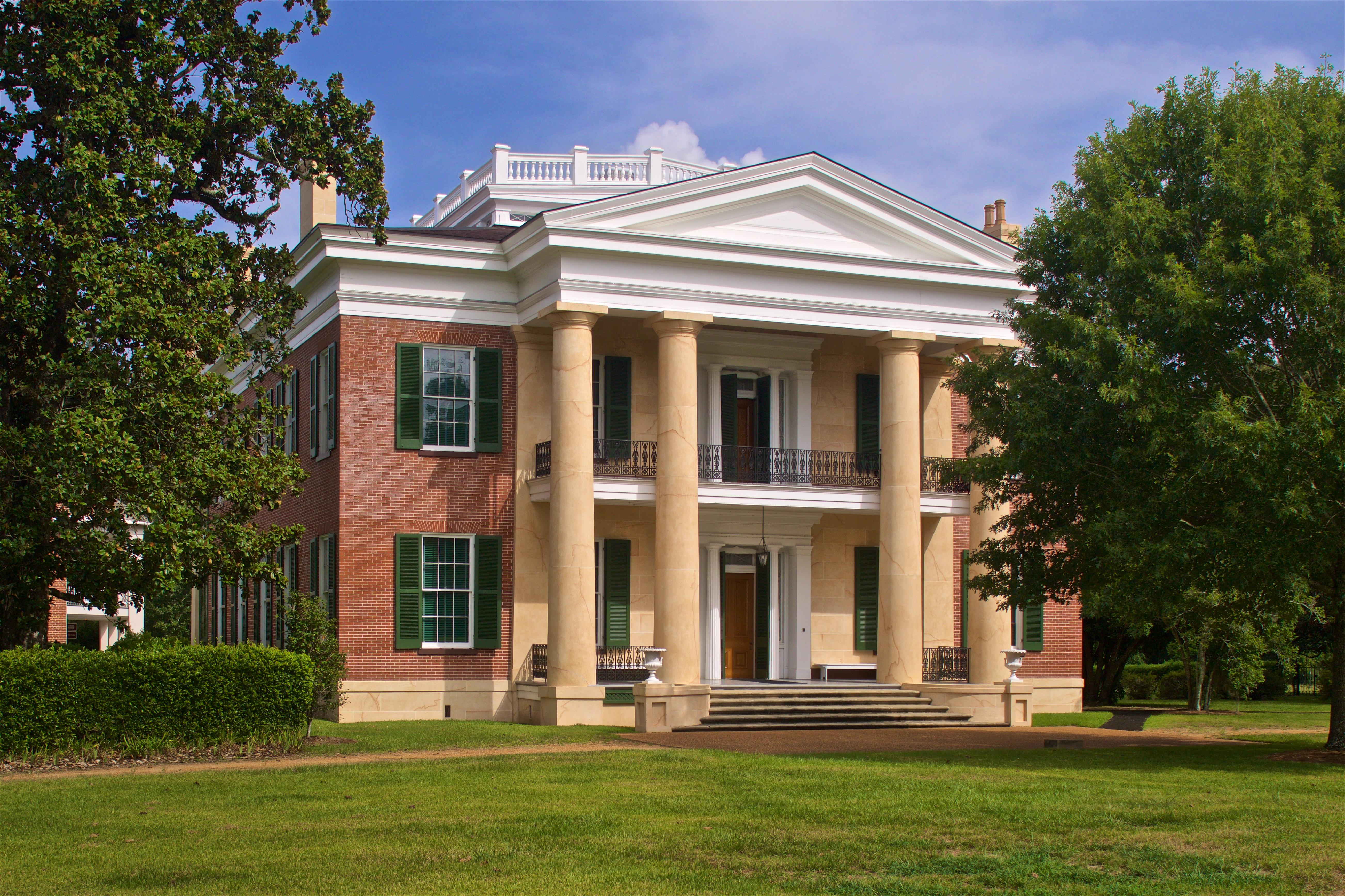 Two story brick mansion with columns