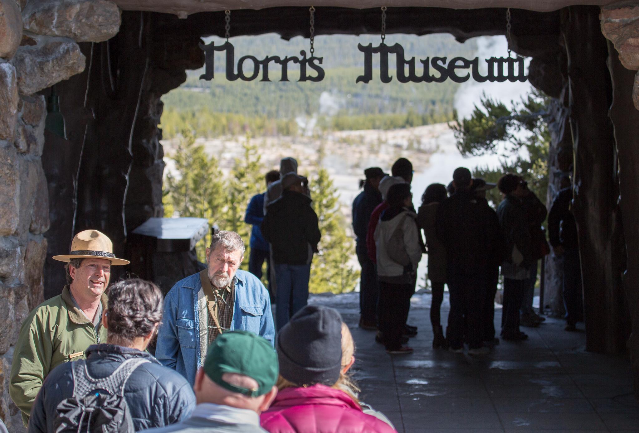 A ranger talks to visitors in front of the Norris Geyser Basin Museum