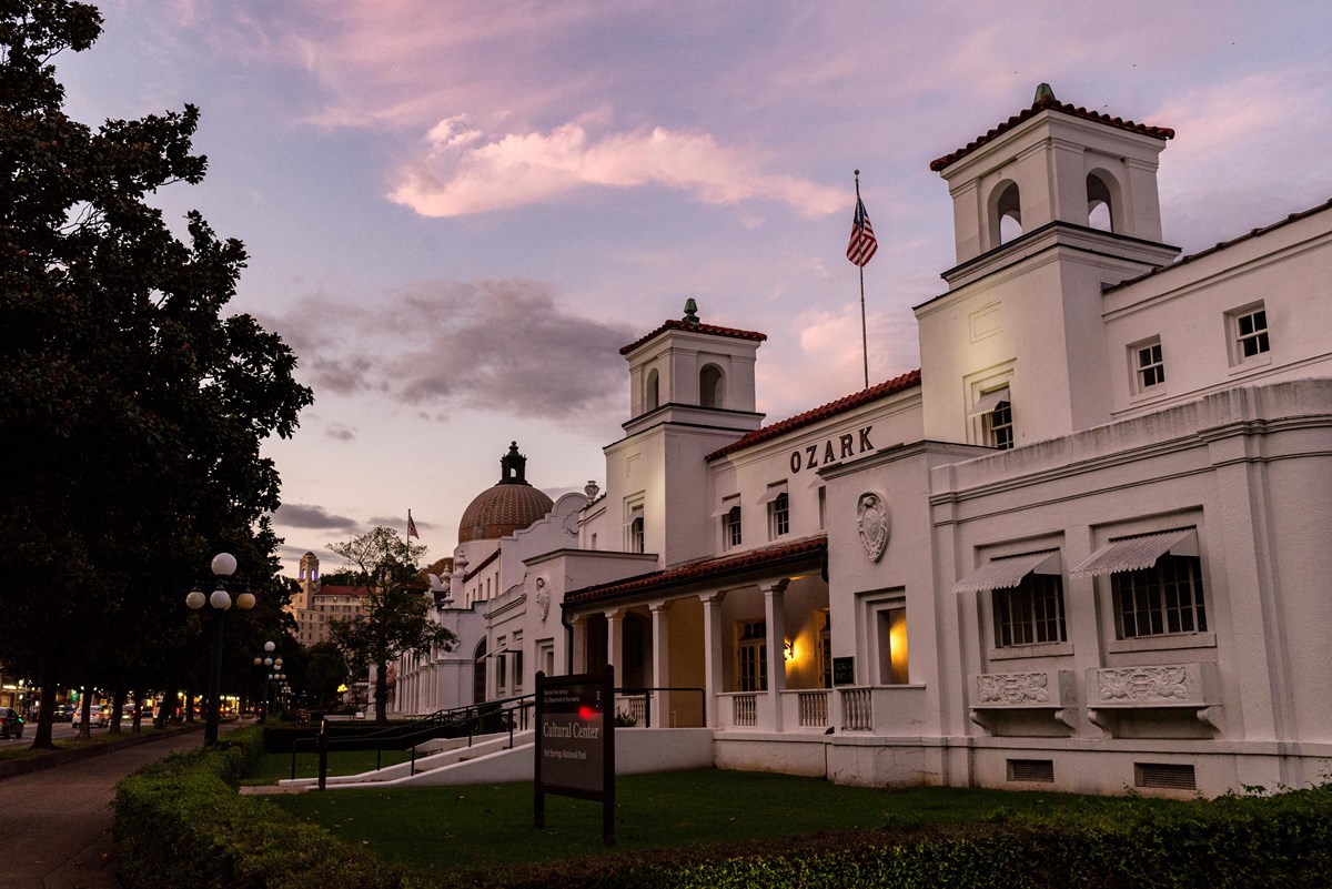 A pink sky above gentle white buildings.