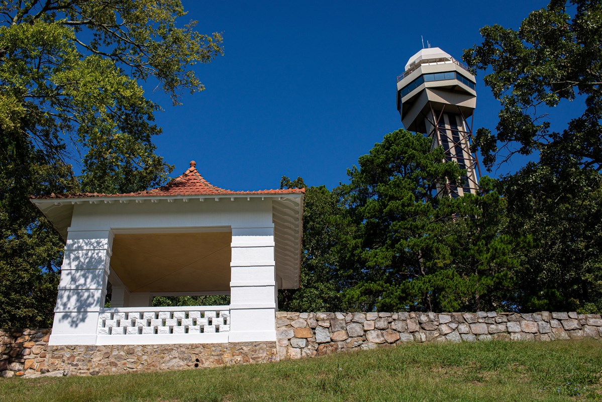 A tower and pagoda on the side of a mountain 