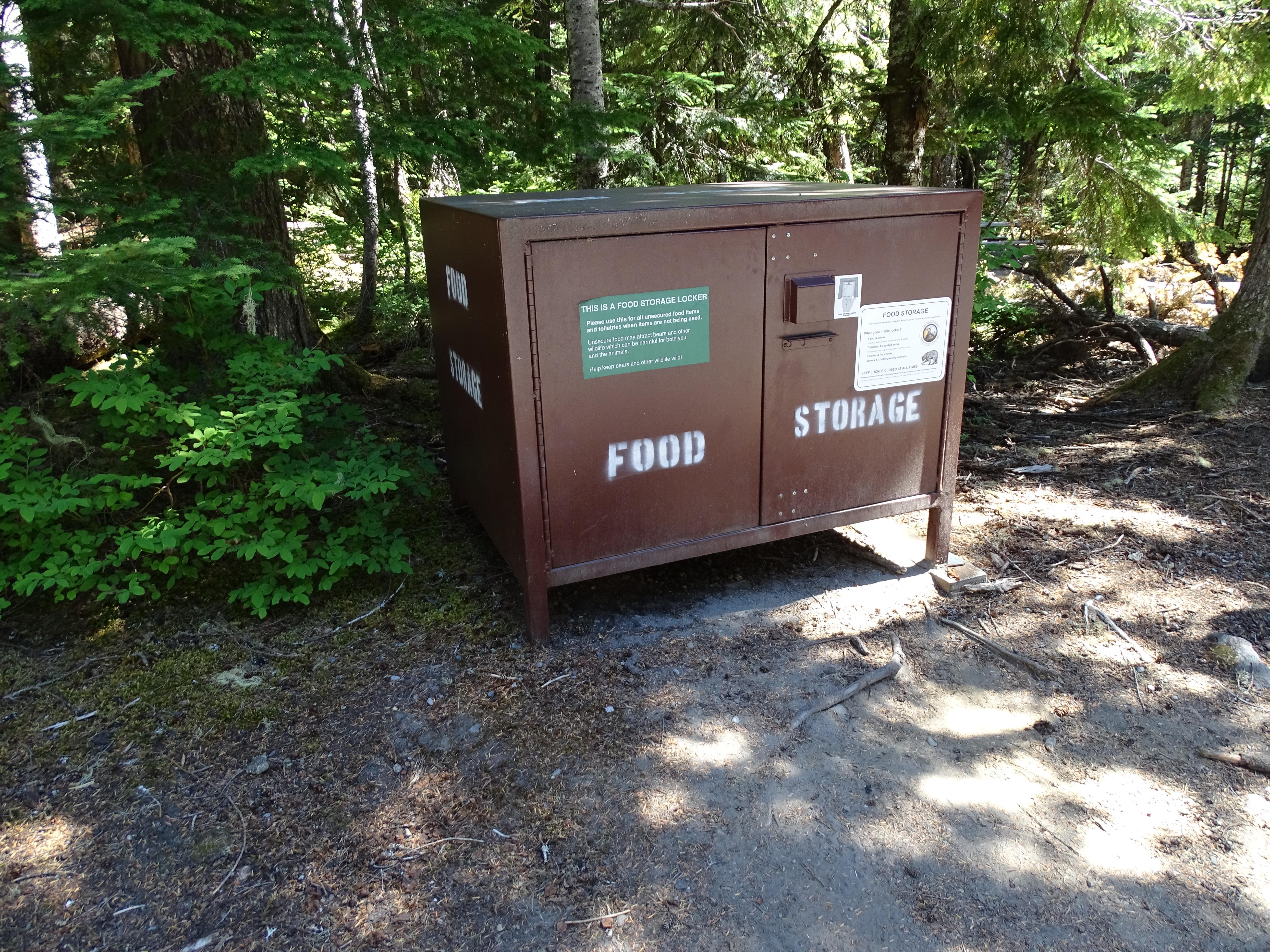 A brown rectangular metal container marked "food storage"