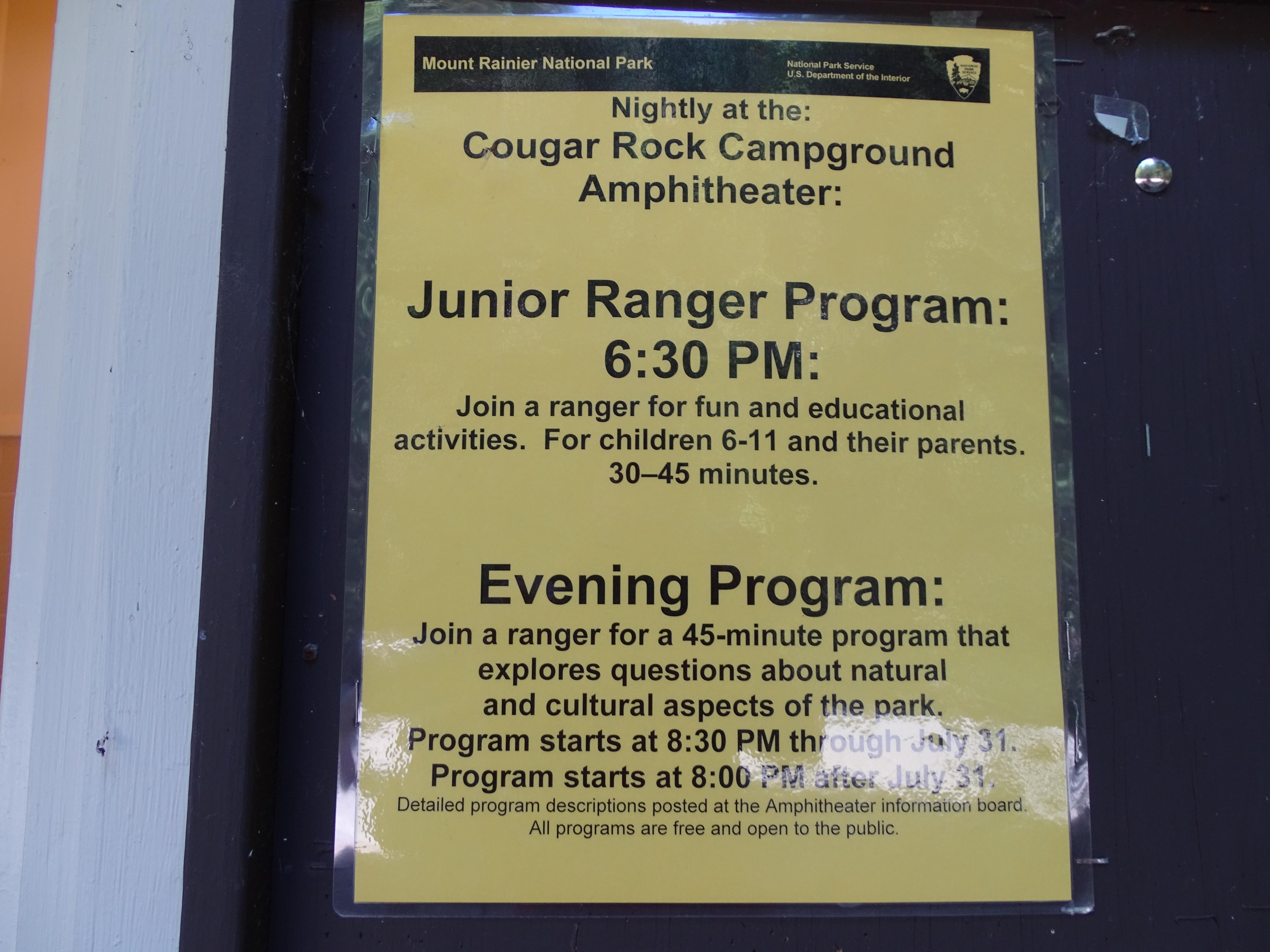 A yellow flyer noting the times of programs.