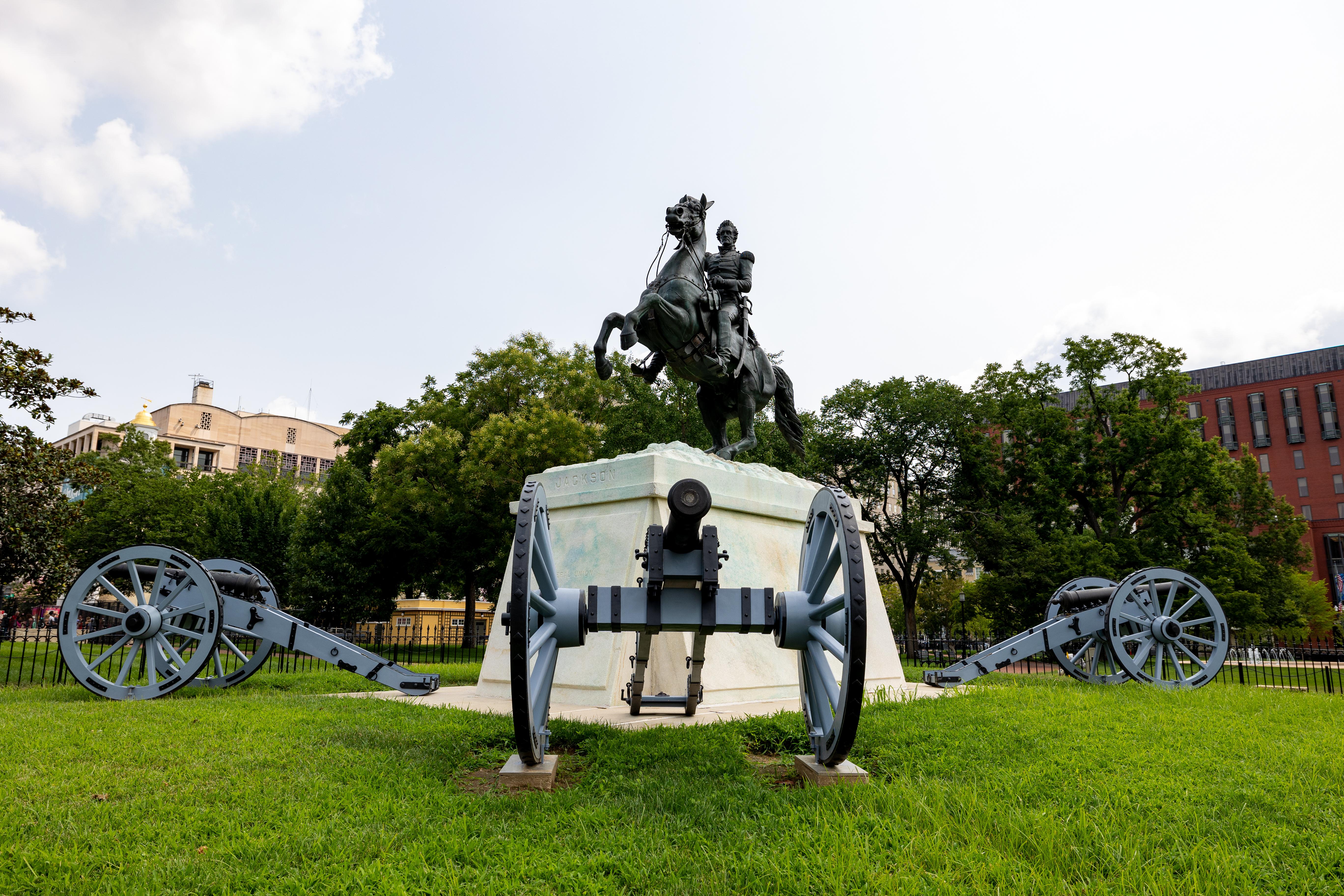 A bronze statue of Andrew Jackson on horseback surrounded by cannons