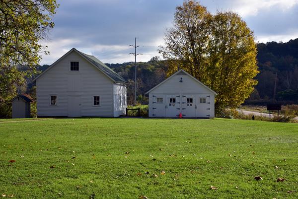 Exterior of Hunt House, a white historical home with a grassy lawn.