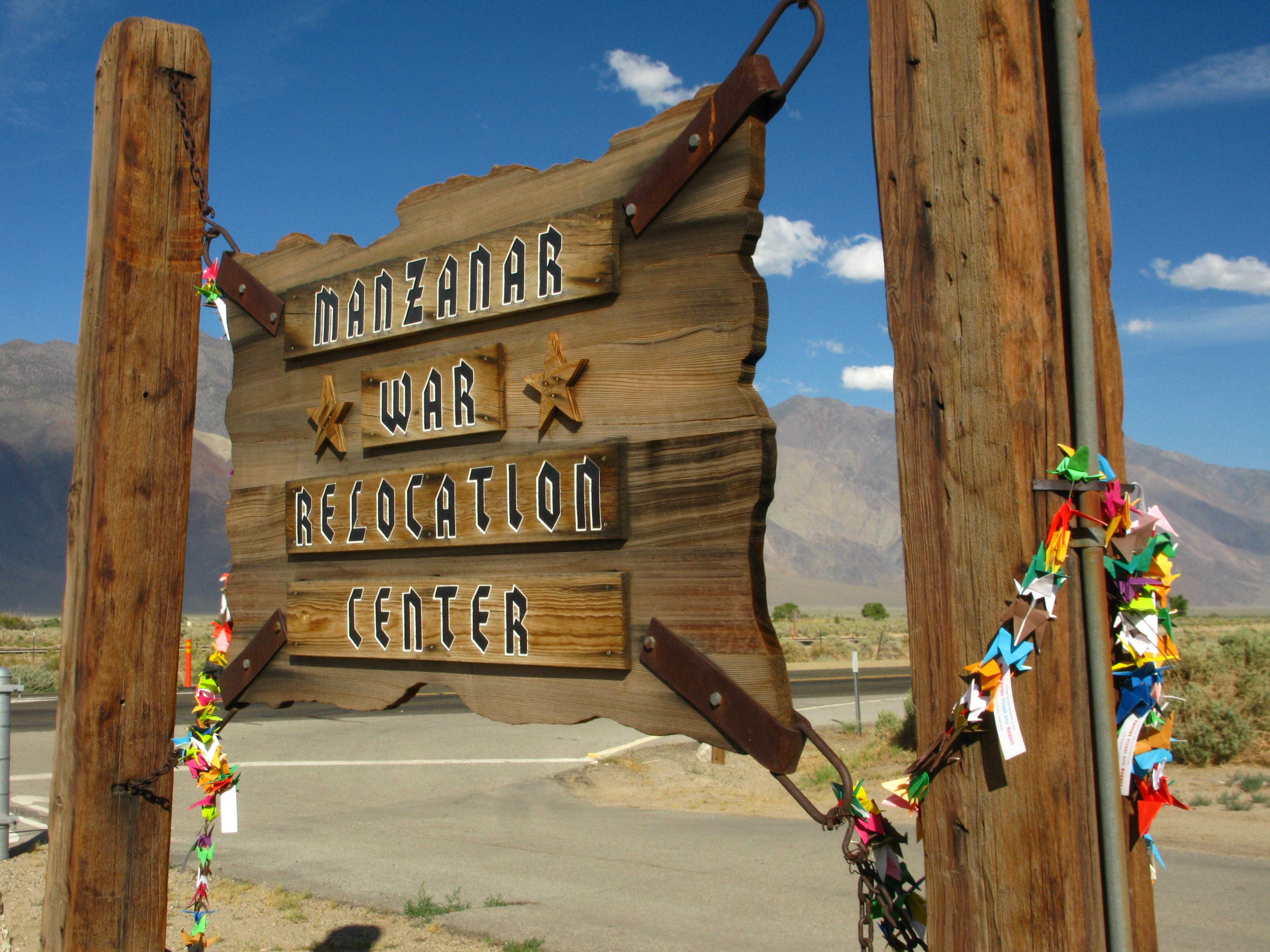 Wooden sign with "Mananar War Relocation Center" written on it