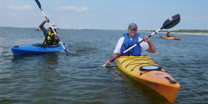 Two kayakers paddle toward the camera.
