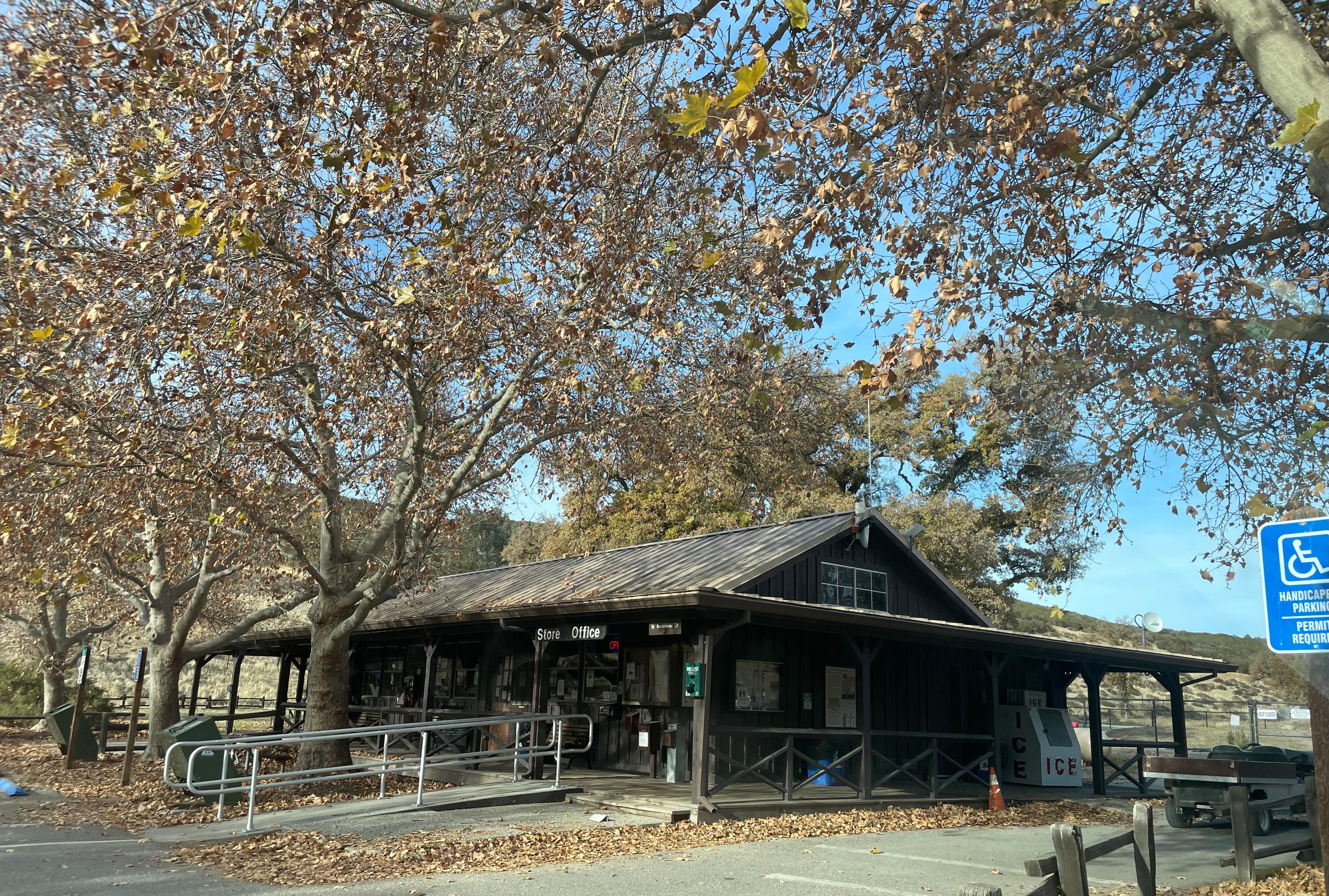 Wooden building featuring a wrap around deck and ramp in early winter