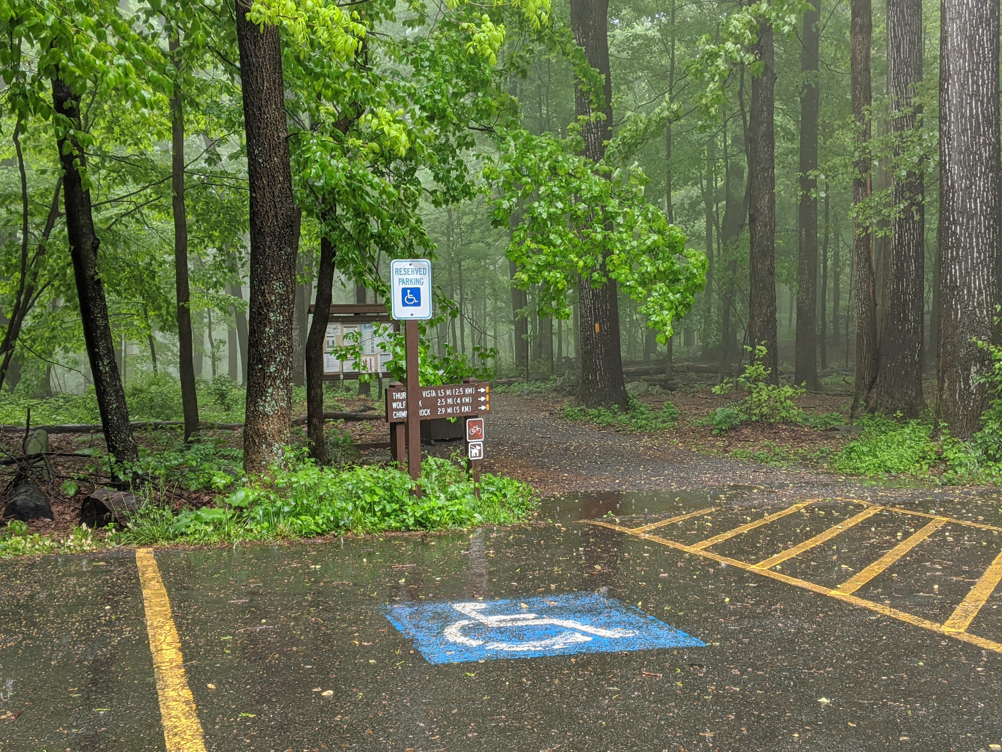 Image of handicapped parking space with a trail directly to its side