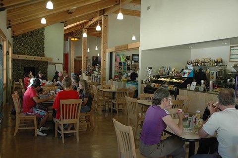 People seated in a small fireside dining area inside the visitor center