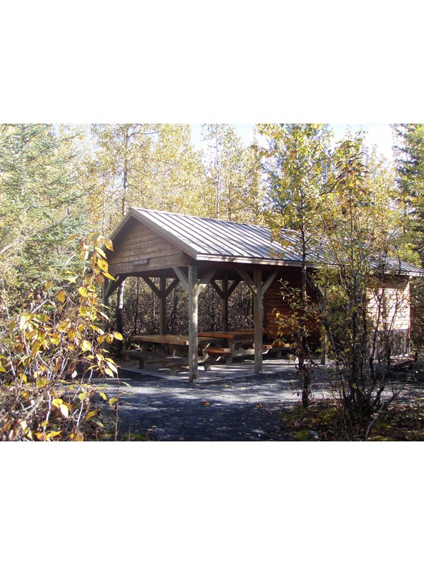 campground covered cook shelter with picnic tables.