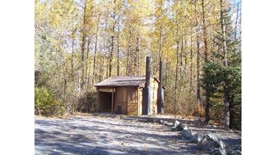 vault toilet in parking lot.