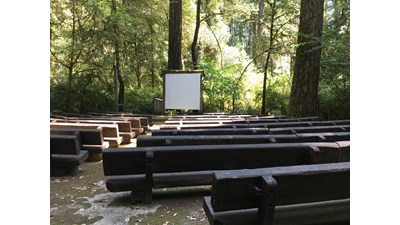Wooden seats in front of a slideshow screen