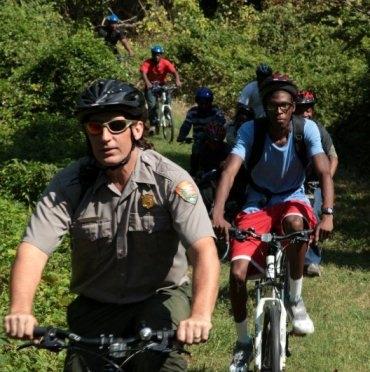 A park ranger leads a bike tour of Fort Dupont