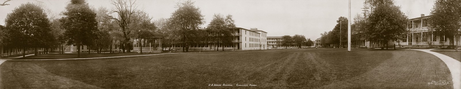 Historic black and white image of a large boarding school campus