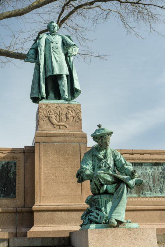 A memorial statue of a young and adult Samuel Colt