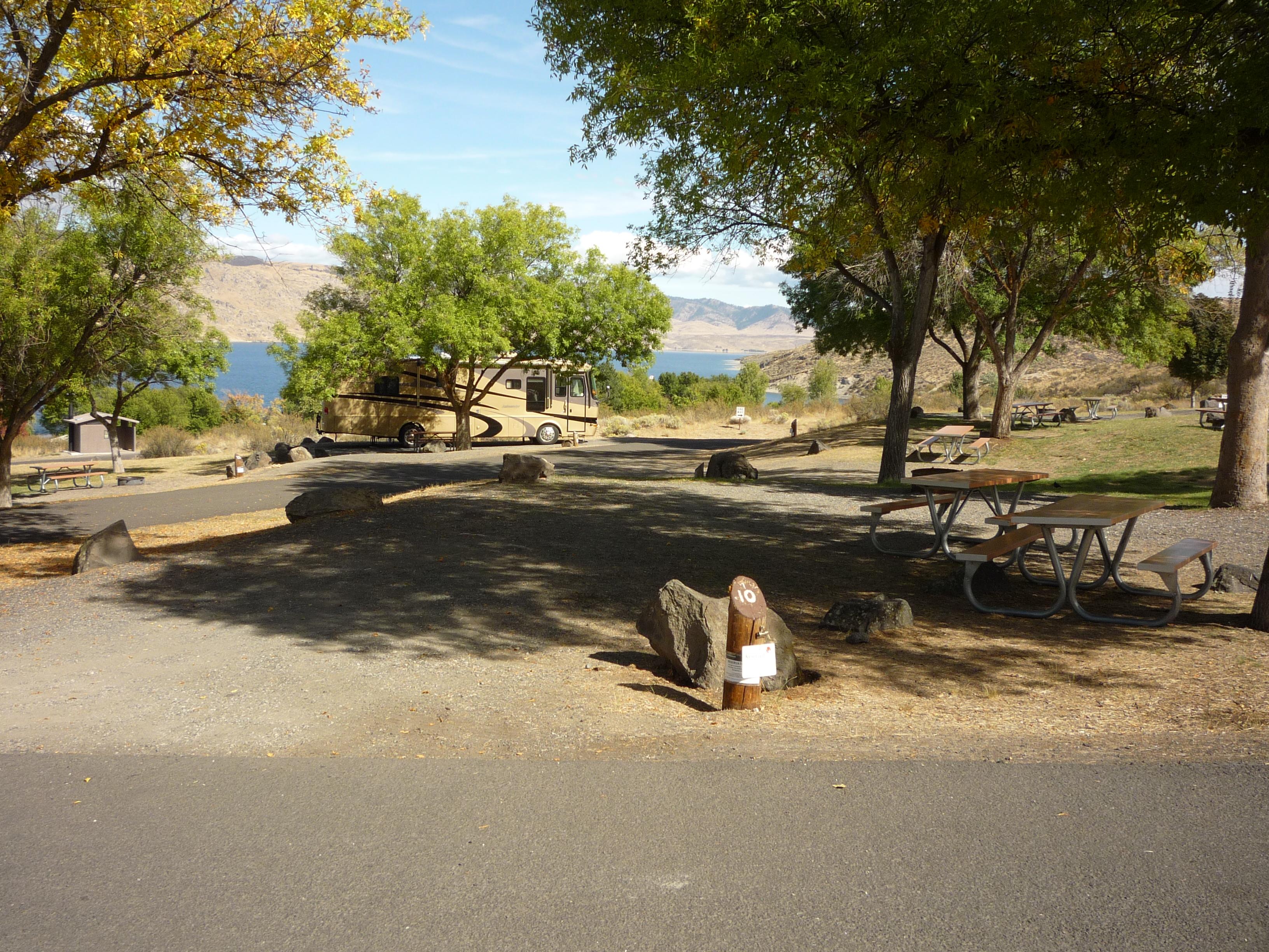 A view of paved access roads and campsites, overlooking the lake.