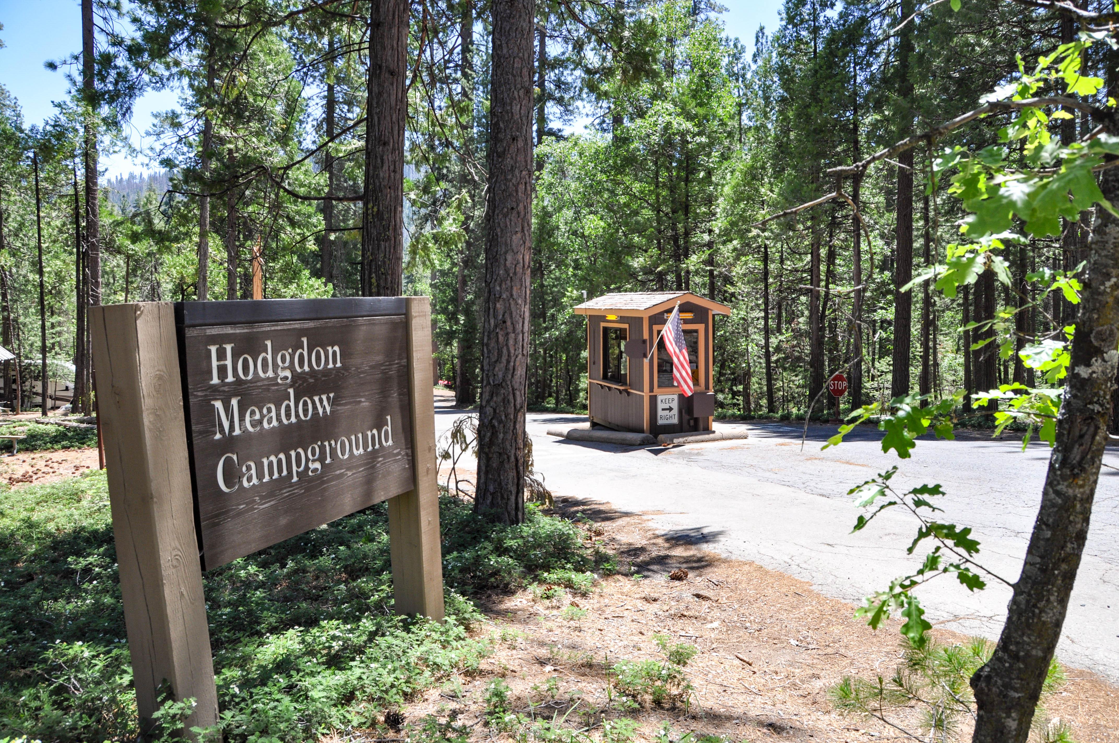 A wooden sign reads Hodgdon Meadow Campground. A kiosk is located at the entrance to the campground.