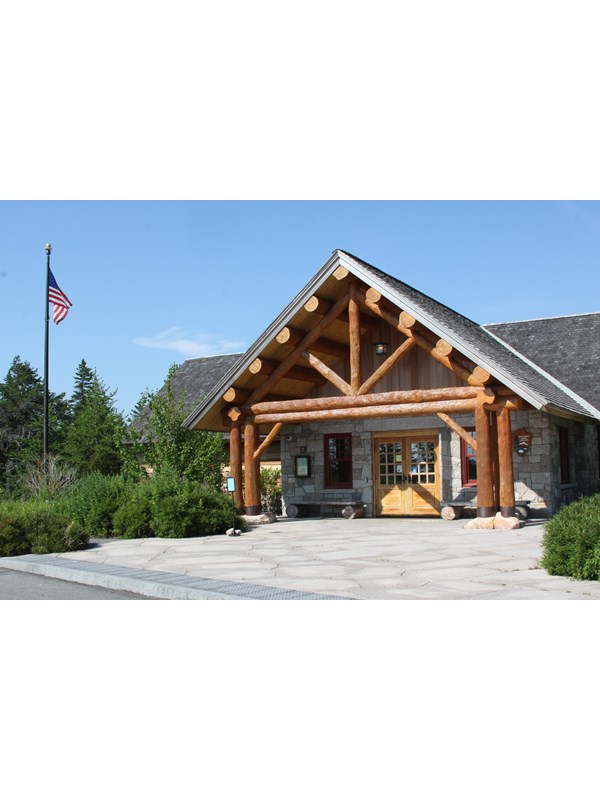 A wooden ranger station building with an A-frame style entrance