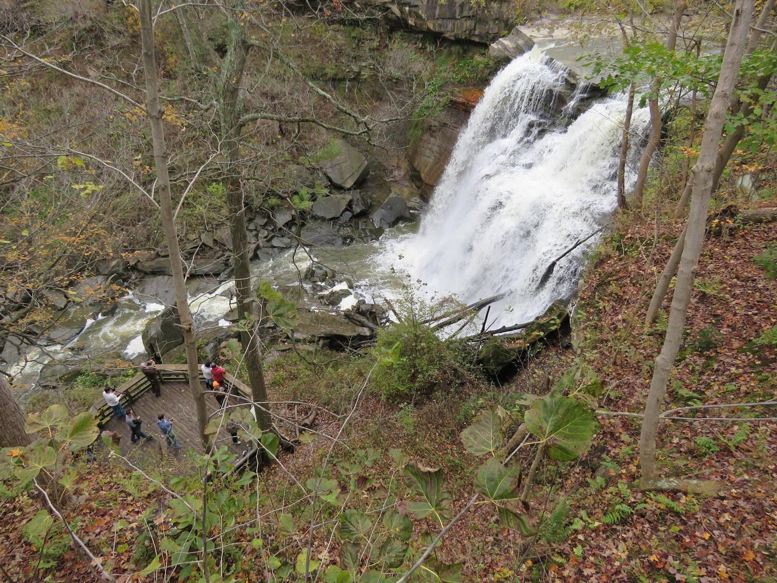 Brandywine Falls and visitors on its boardwalk seen from above.