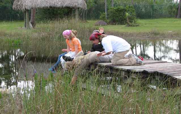 Students doing schoolwork on a dock