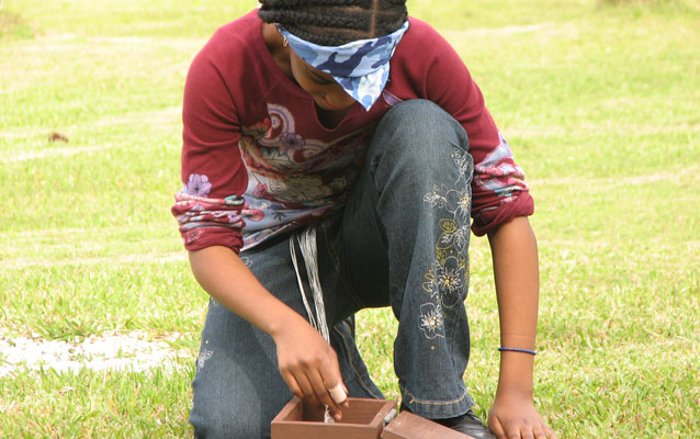 A students looks into a box of goodies.