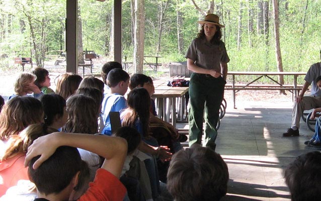 A ranger introduces activities for the day. A ranger introduces activities for the day.