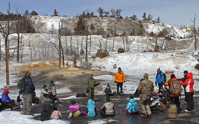 A class group listens to a ranger at Mammoth Hot Springs terraces