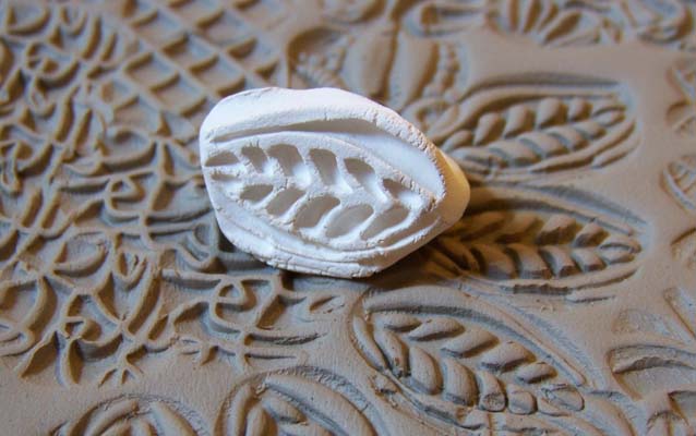 A clay stamping die on top of stamped clay A clay stamping die on top of stamped clay